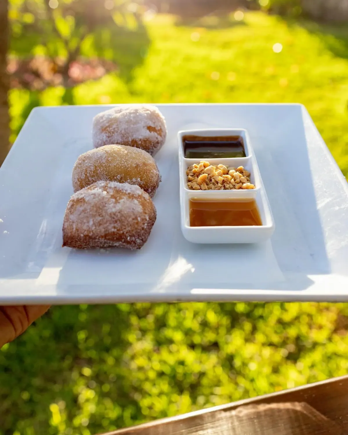 Malasadas with caramel and chocolate sauces